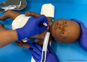 Supporting a child while a tracheostomy tube is inserted into their tracheostomy stoma