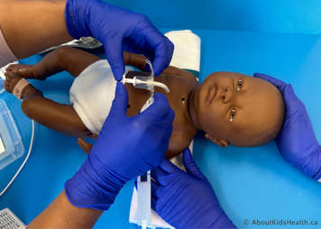 Inserting a tracheostomy tube with two hands