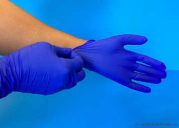 person putting on clean gloves