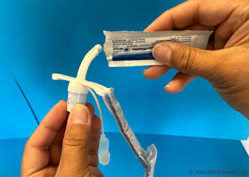 Lubricate the tracheostomy tube using a water-soluble lubricant