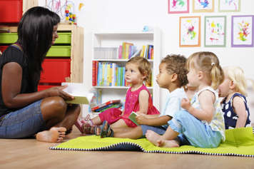 Teacher reading to toddlers