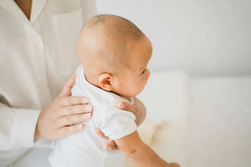 Baby being supported while sitting