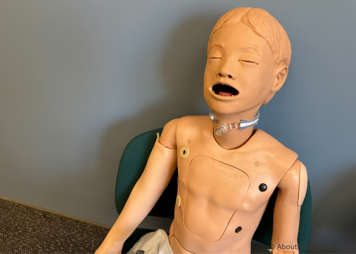 Child sitting upright in a chair