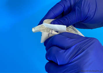 Tracheostomy suction catheter being opened by pushing it through the paper packaging