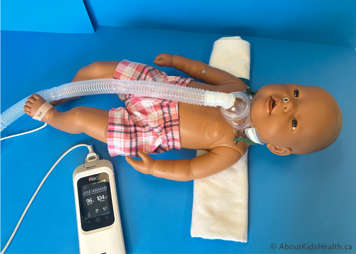 Child with a tracheostomy lying comfortably