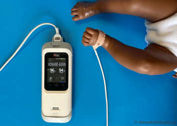 Child wearing oximeter probe on foot