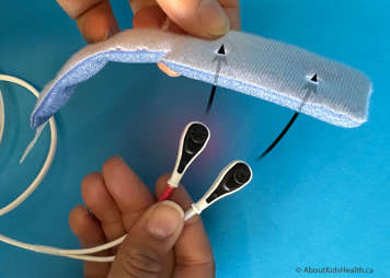 A reusable Y-sensor probe with foam wrap showing the black knobs should be pushed through the dark blue side of the foam wrap