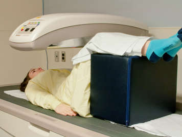 Person lying on their back for a bone mineral density scan