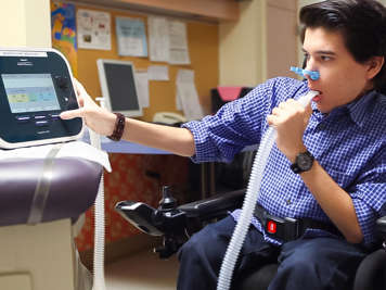 Child using a cough assist machine.