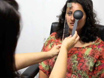 An optometrist measures eye turn