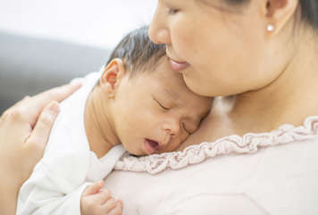 Baby asleep on mother's chest