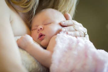 Mother holding baby against her chest