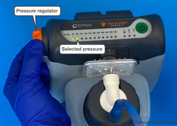 Suctioning device showing the pressure regulator knob and the corresponding display with the selected pressure