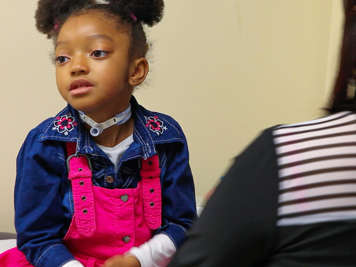 Child with a tracheostomy sitting comfortably