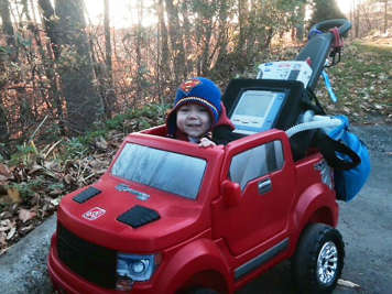 A with a ventilator child playing in a toy car